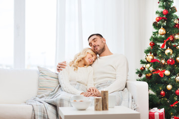 happy couple at home with christmas tree