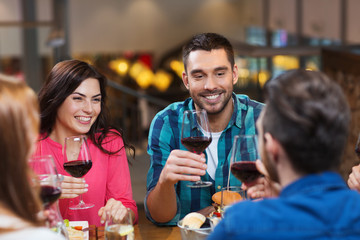friends dining and drinking wine at restaurant