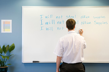 Office worker writing on whiteboard