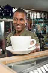 Waiter passing coffee cup