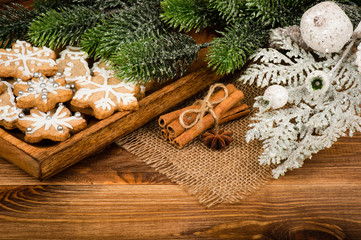 Christmas cookies with cinnamon and anise on the tray on the wooden background.