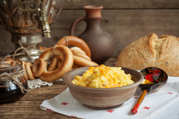 Russian rustic still life: a samovar with bagels, millet porridge