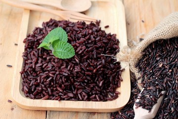 Raw purple rice berries and cooked of delicious for health.
