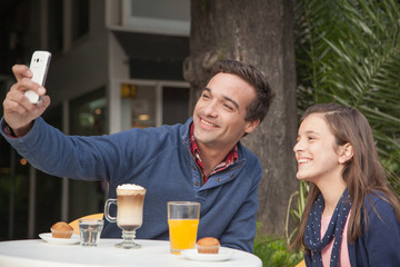 Girl and man in the street looking at camera.