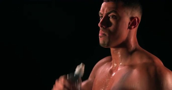 Male bodybuilder drinking water from a bottle