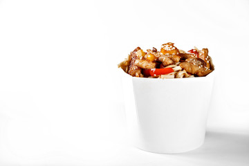 Delicious wok noodles box with sweet sauce chicken and udon. Chinese and asian takeaway fast food. Studio isolated with real shadow