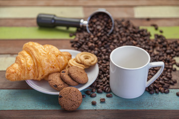 Close up cookies with white coffee cup and beans background