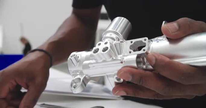 Engineer In Factory Measuring Component With Micrometer