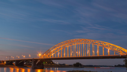 Obraz premium Light up bridge at sunset with twilight