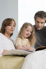 family reading a book