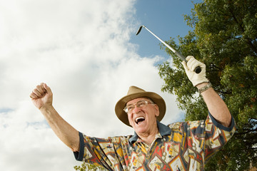 Senior man playing golf