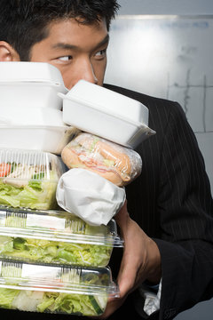 Businessman Holding Lots Of Food