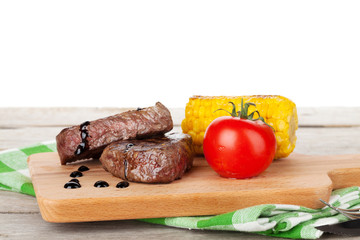 Steak with grilled corn and tomato