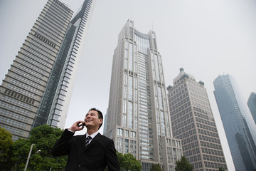Fototapeta na wymiar Businessman near skyscrapers