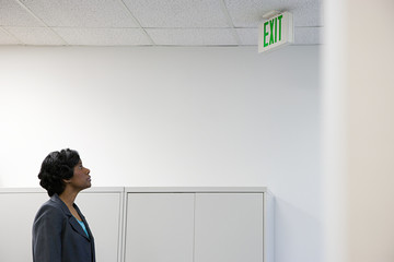 Woman looking at exit sign