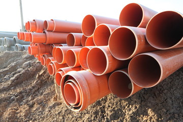 red plastic water pipes construction site