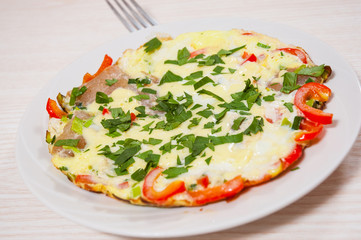 omelet with bacon, vegetables and cheese