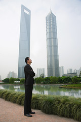 Businessman standing near skyscrapers