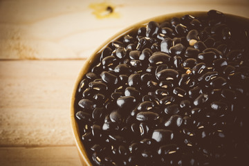 red  beans on wood background - soft focus with vintage film fil