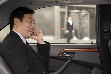 businessman making phone call in the car