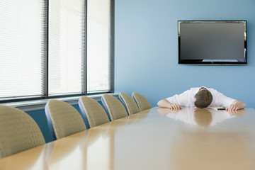 Man sleeping on conference table