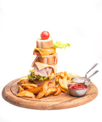 Super huge sandwich with ham and bacon, baked potato, ketchup and sauce