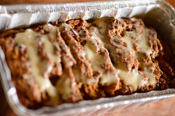 Carrot and orange vegan cake in a foil loaf pan