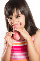 Funny girl eating a pink cake