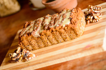 Carrot and orange vegan cake with nuts and vegan condensed milk