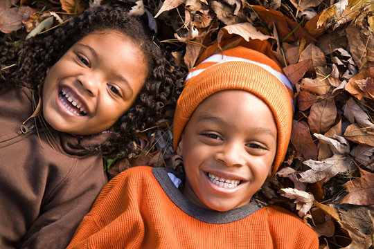 Kids lying on leaves