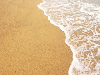 Foamy shoreline in Costa Brava beach at summer