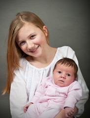 Cute girl with a new born baby