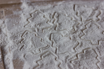 form for christmas cookies on flour