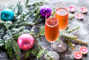 Fototapeta na wymiar Two glasses of champagne with Christmas tree branch