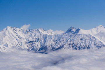 View on mountains and blue sky above clouds, Krasnaya Polyana, Sochi, Russia