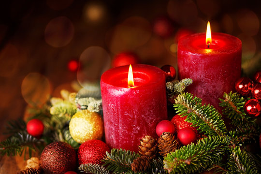 Two burning candles in festive christmas arrangement, 2. Advent