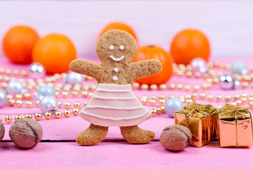 Homemade baked Christmas gingerbread man on vintage wooden backg