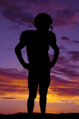 Fotobehang silhouette of football player standing © Poulsons Photography