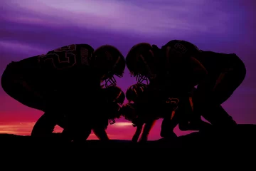 Foto op Canvas silhouette of football players on the line © Poulsons Photography