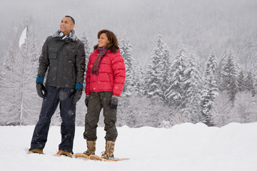 Fototapeta na wymiar Portrait of a mature couple wearing snowshoes