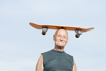 Man with skateboard on his head