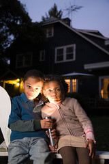 Brother and sister with torch on Halloween