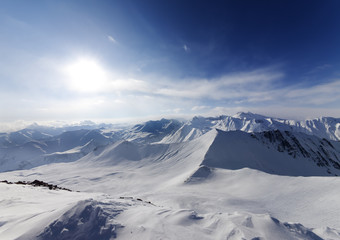 View on off-piste slope and sky with sun