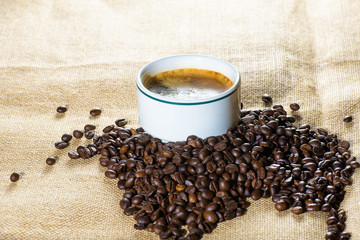 Cup of coffee and coffee beans in sack