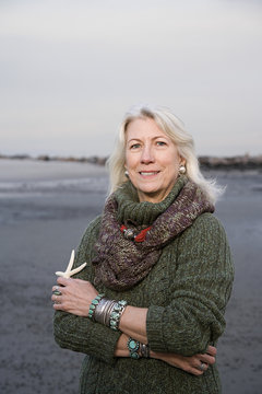Senior woman holding a starfish