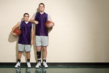 Tall and short basketball players - obrazy, fototapety, plakaty