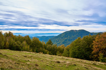 Mountain landscape with clouds and colorful trees