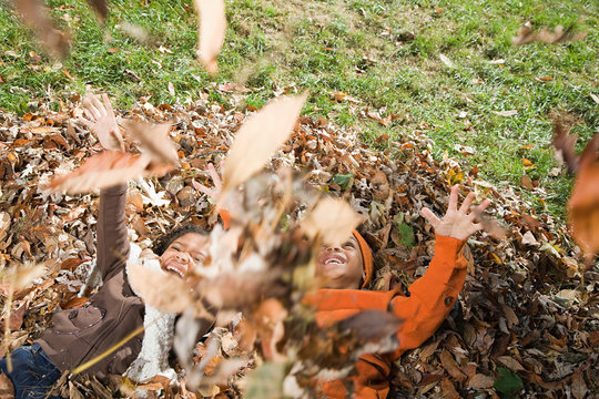 Kids playing in leaves