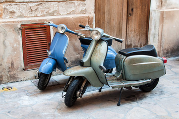 Two vintage scooter parked in the street