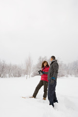 Fototapeta na wymiar Mature couple walking through snow